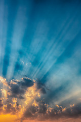besutiful ray of sunlight breaking through clouds at sunset.