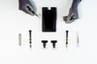 © oksana_bondar - Process of Mobile Phone Display Repair Top View Maintenance Instrument with Copy Space Isolated on White Background. Engineer Hands in Gloves Fix Smartphone Crack Glass. Electronic Technology Service