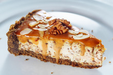 Tasty Cheesecake With Caramel And Walnut Closeup. Sweet Dessert Consisting Of One Layer Made Of Fresh Cheese Soft Mixture And Crust From Crushed Cookies. Delicious Breakfast Or Lunch Dish