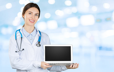 Wall Mural - Portrait of an attractive young female doctor in white coat