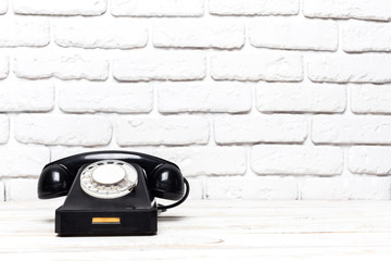 Wall Mural - Retro black telephone on wooden table