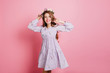 © Look! - Slim lovable girl in purple dress having fun in studio. Indoor portrait of dreamy long-haired woman wears flower wreath.