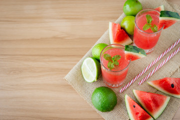 Fruit tropical with drink with spring summer holiday & vacation background concept.Arrangement items fresh ice watermelon  juice on modern brown wooden table.Copy space for design text & word.