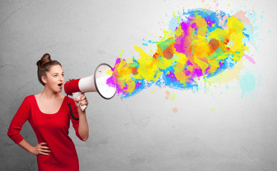 Person with megaphone and colorful splashes
