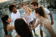 © NDABCREATIVITY - Fitness, sport, training and healthy lifestyle concept - group of happy people exercising outdoor