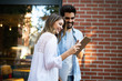 © NDABCREATIVITY - Young couple using a digital tablet together and smiling