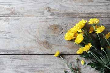 Wall Mural - Vintage yellow chrysanthemums placed on the table old wooden background