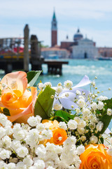 A bouquet of a roses at the San Giorgio Maggiore island background in tne lagoon of Venice background, Italy