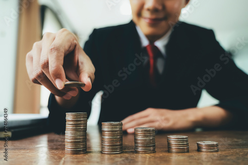 Fotografía Businessman putting coin stack step up increase save money.