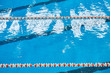 © Fotoproff - Water surface in the sports swimming pool. Blue water and swim lane dividers. Sports and health concept.