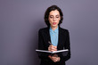 © deagreez - Portrait of cute charming focused lady freelancer hold hand diary essay editor want meeting briefing attentive wavy curly hairstyle isolated grey background