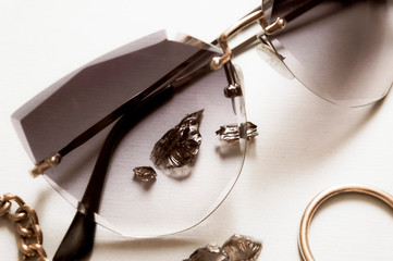 Close up sunglases and jewerly black stone, ring necklace. Fashion background.