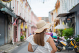 Fototapeta Uliczki - young woman in the old town of Phuket city in Thailand,Travel concept background