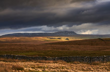 Storm Clouds And Sunshine Over The Three Peaks Summit Of Pen-y-ghent Near Horton In Ribblesdale In The Yorkshire Dales, England.