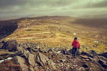 A Hiker Descending The Summit Of Ingleborough Towards Simon Fell In The Yorkshire Dales, England.