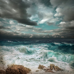 Stormy sea view  near coastline at evening time. Waves, splashed