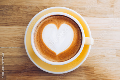 Top View Of Hot Cappuccino Coffee Cup On Wooden Tray With Heart