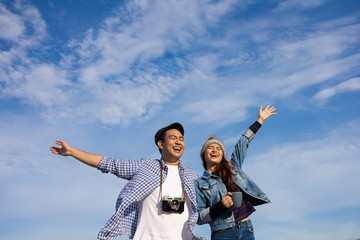 Asian couple camping travel on the hill near the beach