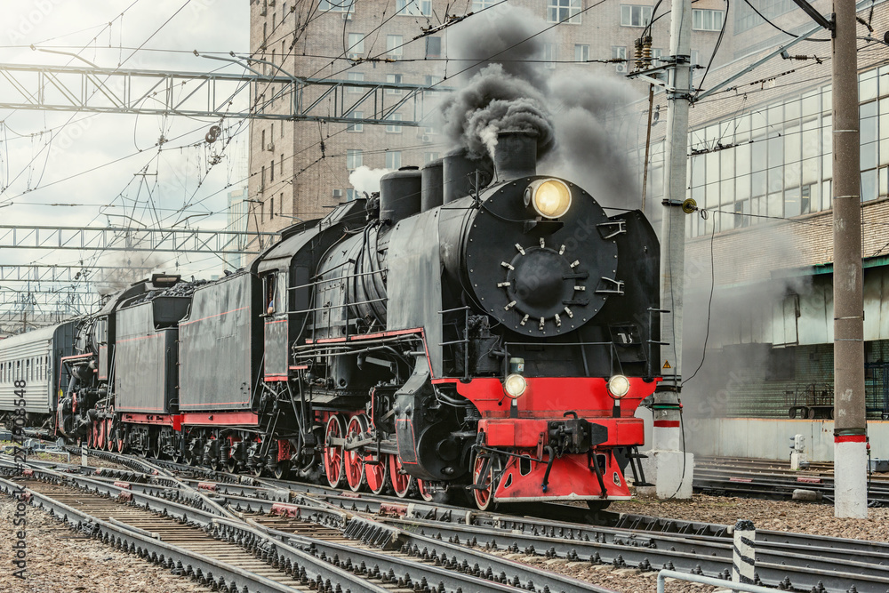 Retro train departs from Kazan railway station building. Moscow. - obrazy, fototapety, plakaty 