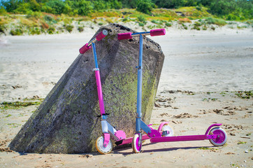 Two kickboard. Child riding scooter. Active outdoor fun for kids. Summer sports for preschool children.