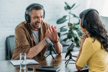 Cheerful Radio Host Showing No Sign While Recording Podcast With Colleague
