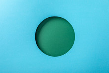 Blue Paper Background With Green Round Hole