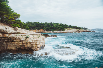 Wall Mural - rocky beach with big cliffs stormy weather big waves