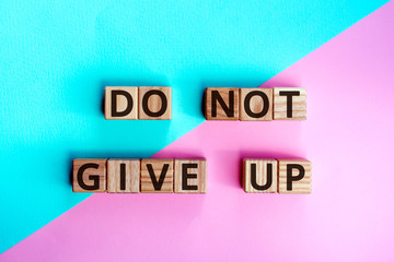 Fototapete - phrase do not give up, wooden cubes with letters on color background top view