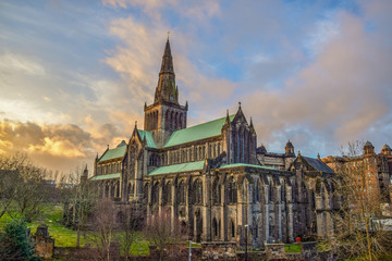 Wall Mural - Beautiful Glasgow St Mungo’s Cathedral illuminated clouds in sunset	