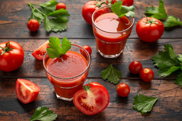 Wall Mural - Tomato juice in glass with celery on rustic wooden table