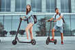 © Fxquadro - Young attractive couple is enjoying nice summer day while riding their own electro scooters.