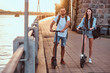 © Fxquadro - On bright sunshining day attractive couple had nice electro scooter riding by riverside.