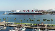 Aerial View Of Queen Mary Ship And Landmark Docked In The Long Beach Harbor In California On A Sunny Day.