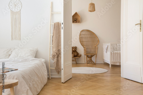 Scandinavian Bedroom With White Bedding On The Bed And Door Open