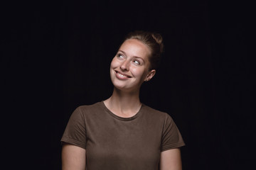 close up portrait of young woman isolated on black studio background. photoshot of real emotions of 