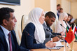 © pressmaster - Young successful female delegate in hijab taking part in discussion
