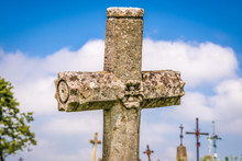 Stone Cross On Abandoned Catholic Cemetery Near Chervonohorod Castle Ruins In Ukraine