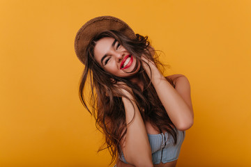 cheerful long-haired girl with trendy makeup enjoying good day and happy smiling. studio shot of eas