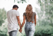 © ASDF - Couple in love walking in park holding hands