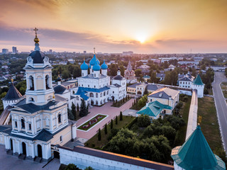 Aerial view of the ancient Orthodox Christian monastery, located among the houses and nature in the city of Serpukhov. Early summer morning. Moscow region