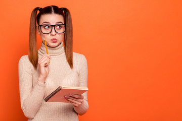 Wall Mural - Close up photo beautiful amazing she her lady wondered pretty hairdo look side empty space planner pencil pen hands arms pensive ponder wear casual pastel pullover clothes isolated orange background