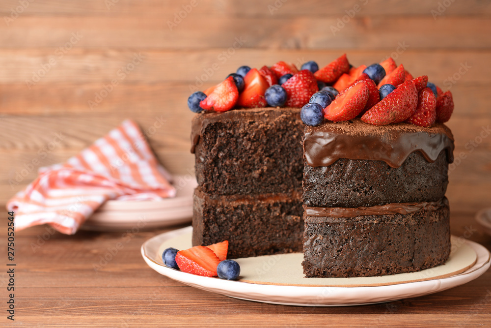 Tasty chocolate cake on wooden table