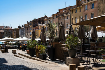 Restaurant terraces under  umbrellas on the place des Cardeurs at Aix-en-Provence city. France 2019.