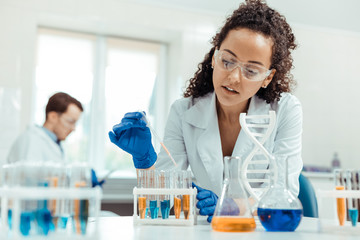 Wall Mural - professional female scientist taking a vaccine sample