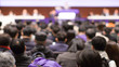 Conference with panel speakers on stage at convention. Presenters at corporate seminar talking to audience.  Business leadership lecture during executive seminar.