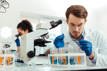 Wall Mural - smart young man working as a biologist