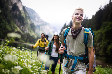 hiking with friends is so fun. group of young people with backpacks hiking together