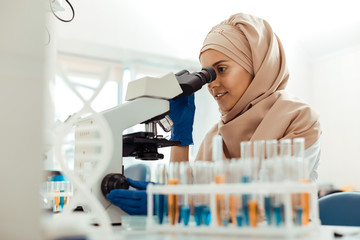 Wall Mural - positive muslim woman being at work in the lab