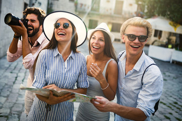 Happy group of tourists traveling and sightseeing together