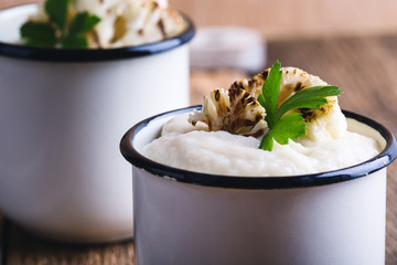 Wall Mural - Healthy cauliflower cream soup in rural mugs